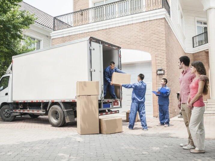 moving company workers organizing items into a long distance moving truck in Woodland, CA